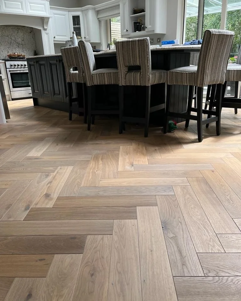 Herringbone flooring in a kitchen and dining space